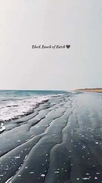Ripples of dark sand along the shoreline of a black sand beach in Kutch