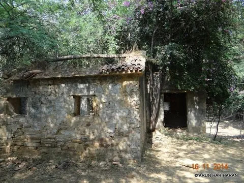 Old stone building with a tiled roof among trees at Chadva Rakhal