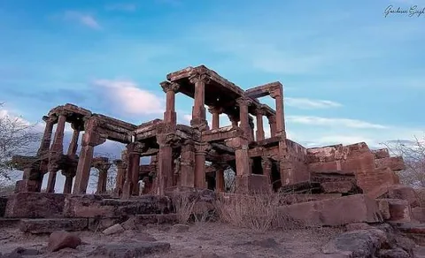 Ruined stone pavilion with carved pillars and beams at Paddhar Gadh