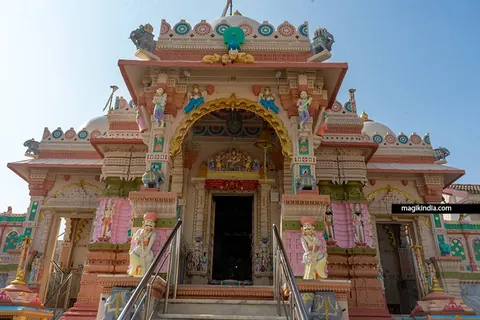 Painted temple entrance with sculpted guardian figures at Tera Jain Tirth