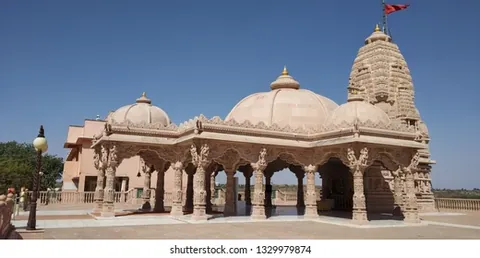 Domed sandstone temple at Vandhay with a carved spire and pillared pavilion